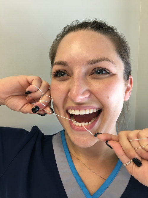 Our Dental Assistant Chelsae flossing after Lunch